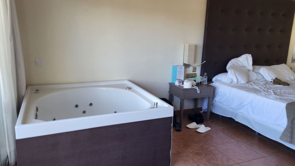 A photo of a hot tub inside a hotel room.